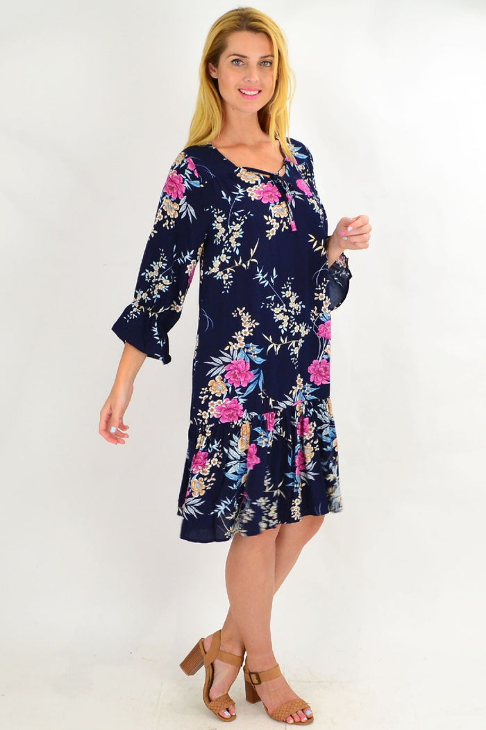 Navy Carnation Flower Sleeve Tunic Dress by Hourglass, featuring floral sleeve design and flowing fabric, front view.
