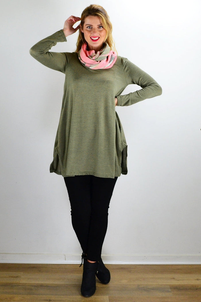 Olive green knit tunic top by Hourglass displayed on a hanger, showcasing its soft fabric and relaxed fit style.