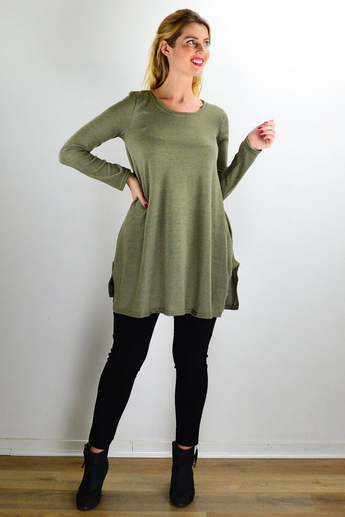 Olive green knit tunic top by Hourglass, featuring a relaxed fit and textured fabric, displayed on a hanger.