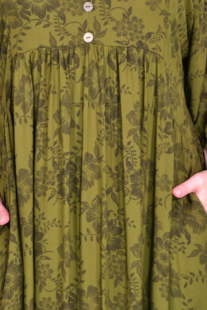 Olive green Willow Tree peasant tunic dress with loose fit and flowing fabric, displayed on a hanger.