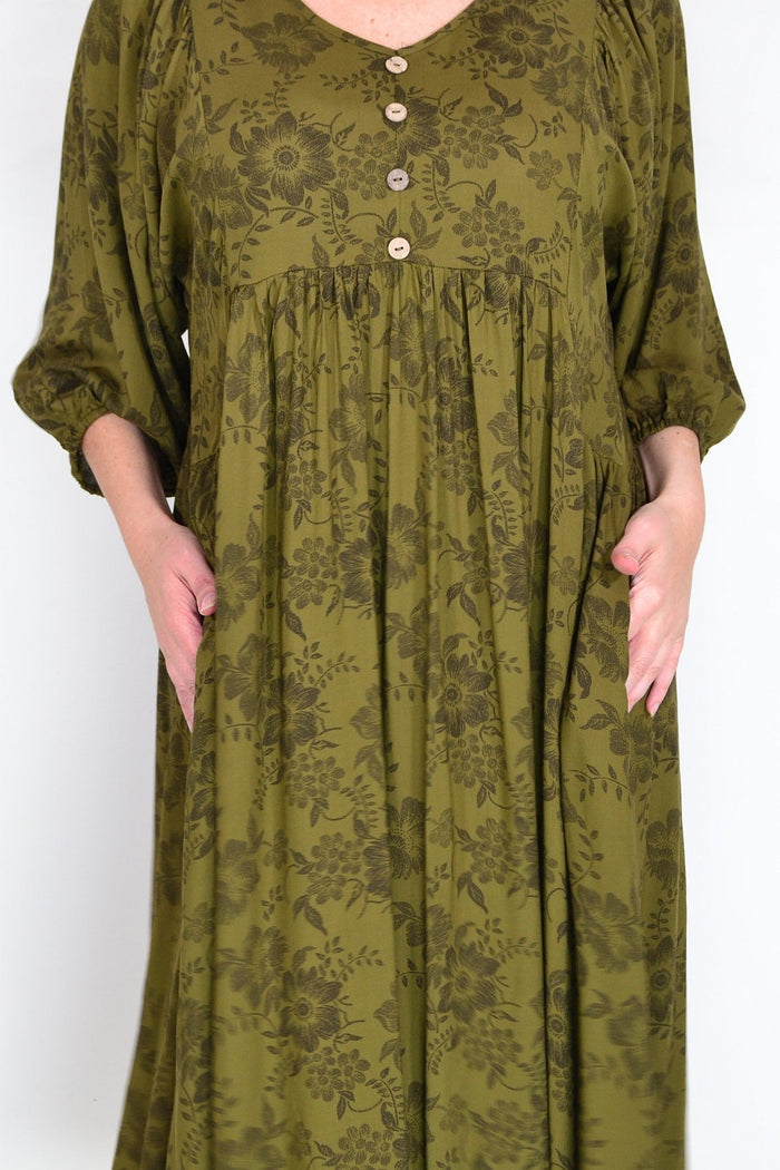 Olive green Willow Tree peasant tunic dress with flowy fabric and relaxed fit, displayed on a hanger.
