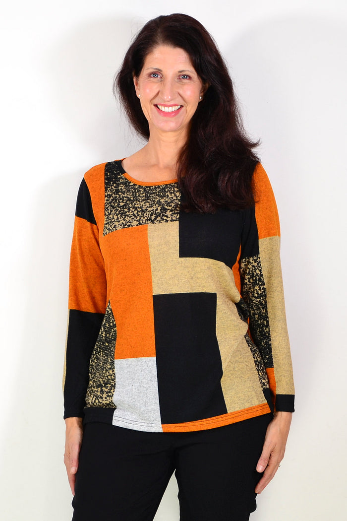 Orange and black geometric print tunic top by Hourglass, featuring a stylish, casual design with long sleeves and a relaxed fit.
