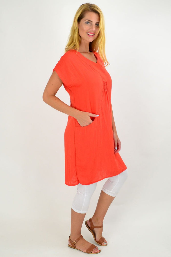 Orange Willow Tree tunic dress with long sleeves and a relaxed fit, displayed on a hanger.