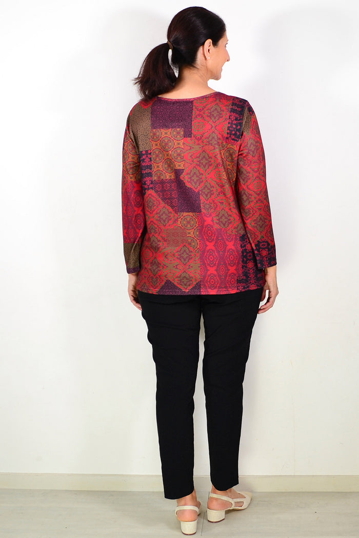 Oriental red printed tunic top by Hourglass with long sleeves and a relaxed fit, displayed on a hanger in the image.
