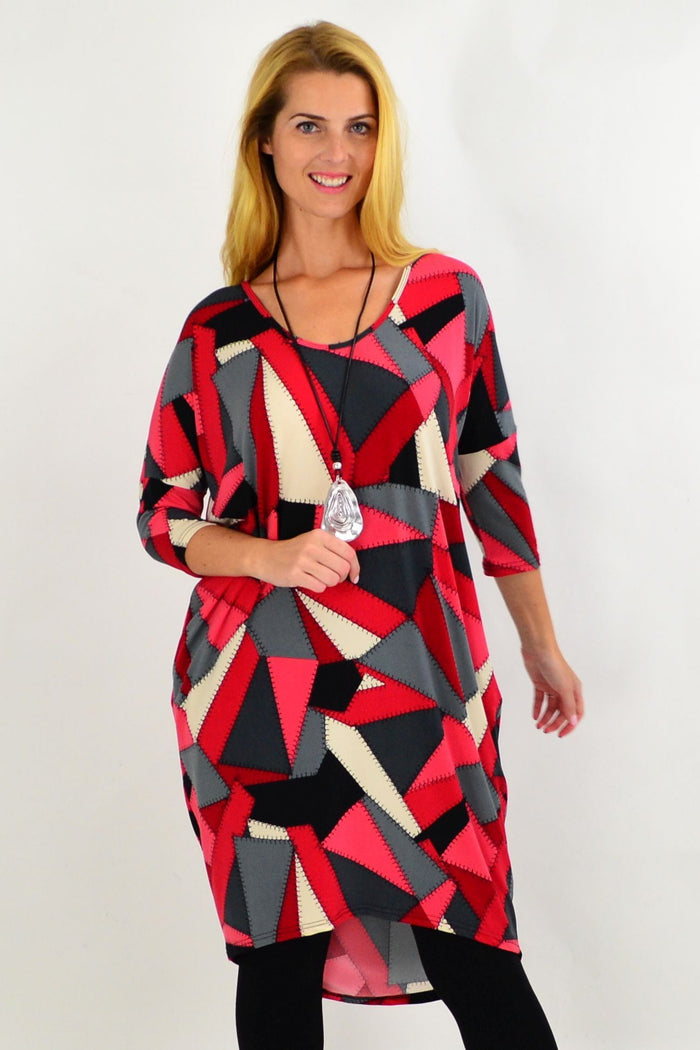 Red and grey patchwork hi-low tunic dress by Four Girlz, featuring a stylish, flowing design perfect for casual wear.