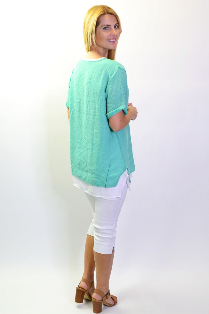 Envogo peppermint slice tunic top displayed on a hanger, showcasing the stylish design and vibrant color.