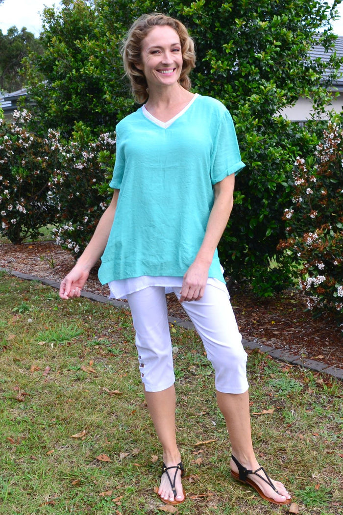 Envogo peppermint slice tunic top displayed on a hanger, showcasing its vibrant color and casual, comfortable style.