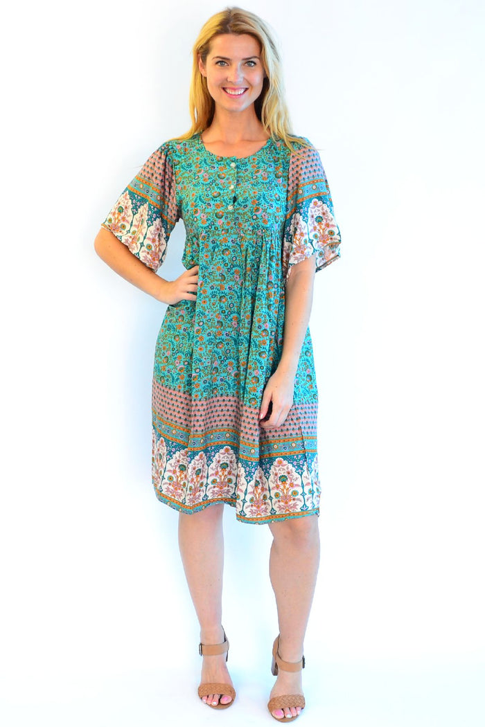 Bohemian green Persian Palace bell sleeve tunic dress by Hourglass, featuring flowing fabric and intricate embroidery details.