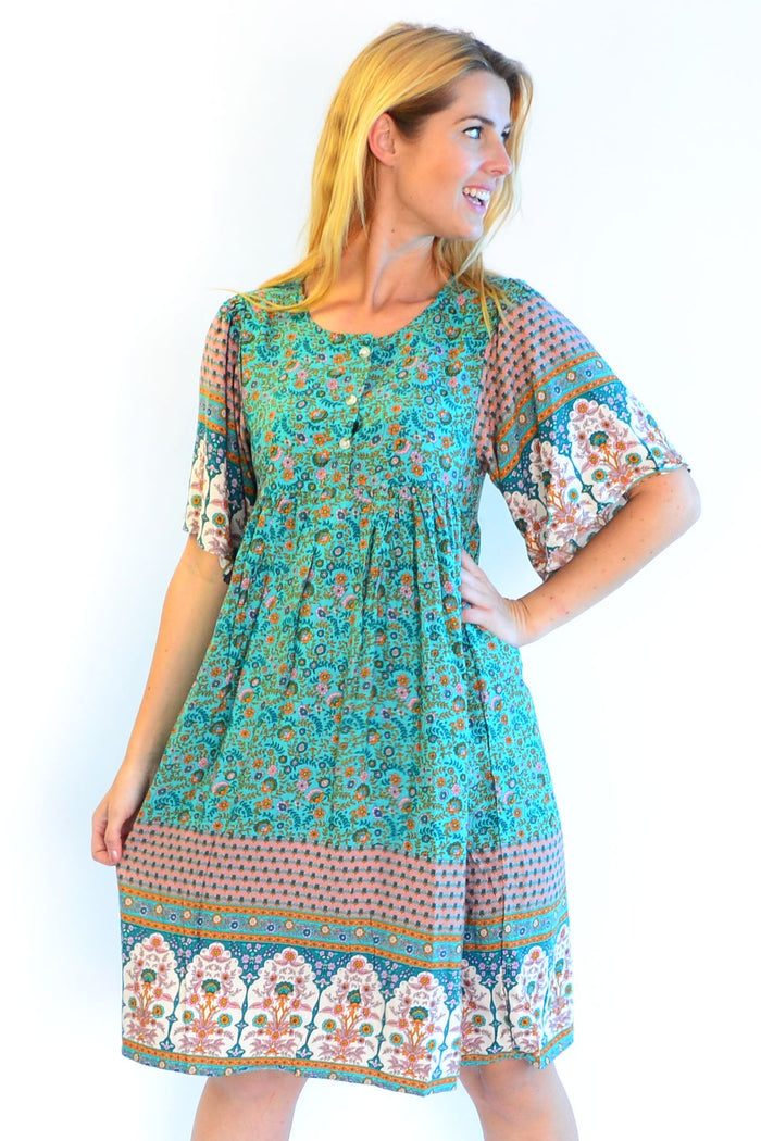 Bohemian green Persian Palace bell sleeve tunic dress by Hourglass with intricate embroidery and flowing silhouette.