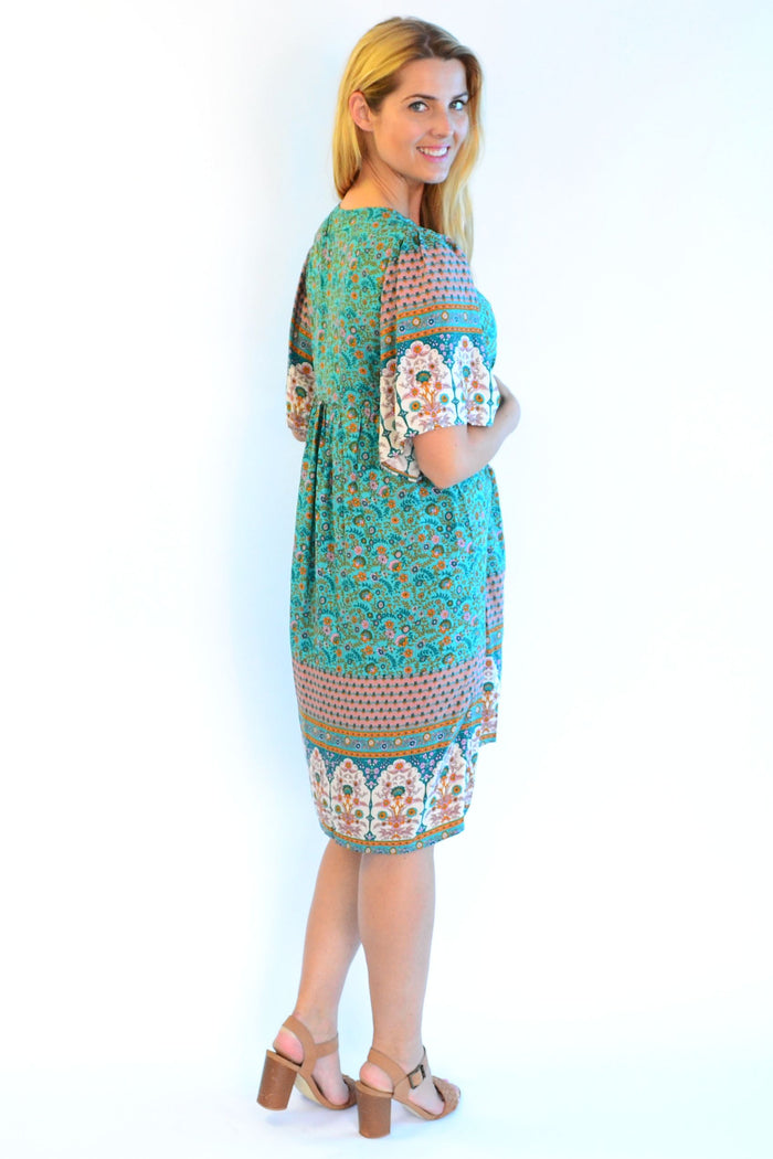 Bohemian green Persian Palace bell sleeve tunic dress by Hourglass featuring intricate patterns and flowing fabric.