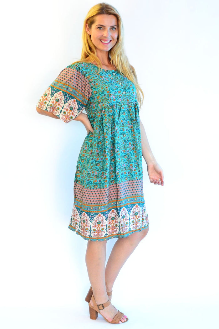 Bohemian green bell sleeve tunic dress by Hourglass with intricate patterns, flowing fabric, and relaxed fit for a stylish look.
