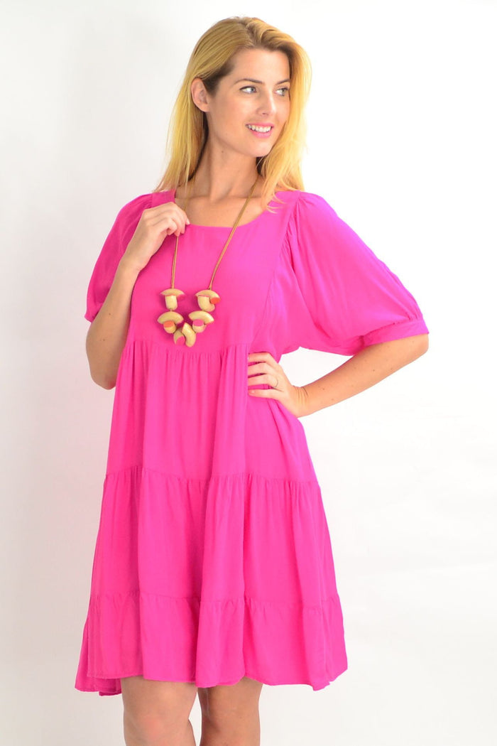 Pink Willow Tree tiered tunic dress with a relaxed fit, perfect for summer casual wear, shown on a hanger against a plain background.