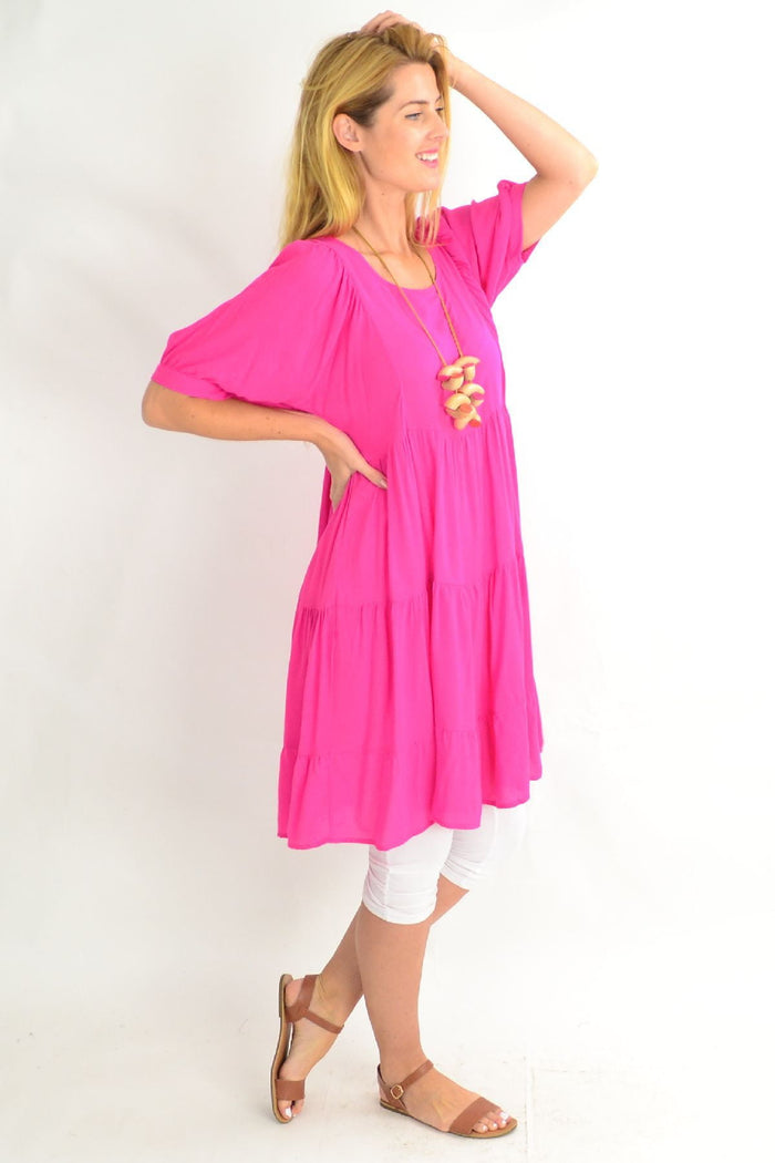 Pink Willow Tree classic tiered tunic dress, lightweight fabric, with ruffled layers and long sleeves, styled for casual wear.