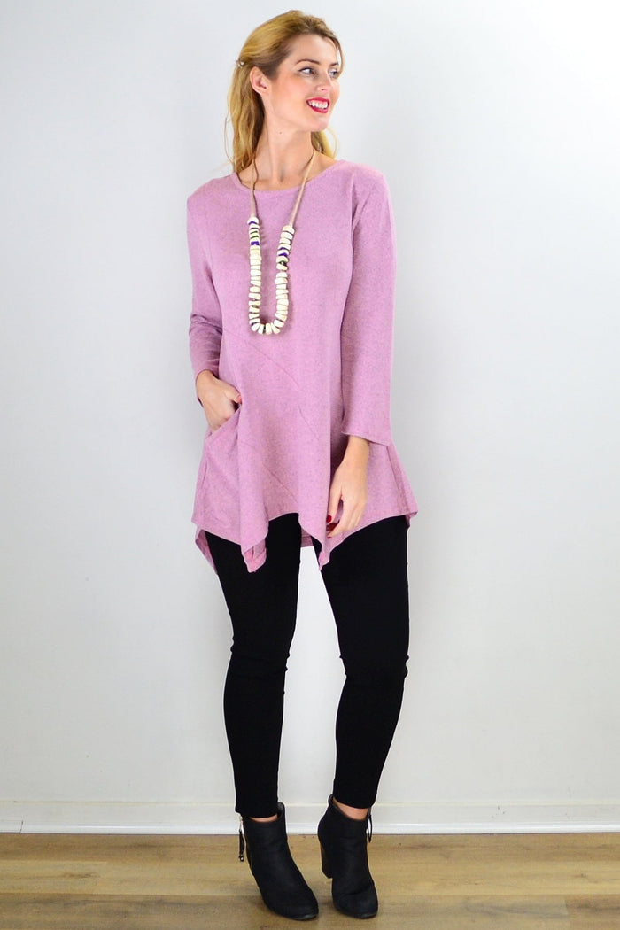 Pink Peony pocket winter tunic top with long sleeves and a relaxed fit, styled with a high neckline and cozy fabric.