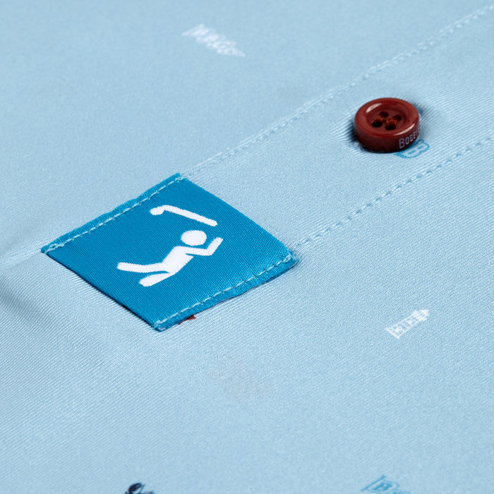 A close-up of the Port - Polo in light blue shows a teal square patch with a white stick figure climbing, athletic fit, red-brown buttons, faint white printed text, and textured stitching on the fabric.
