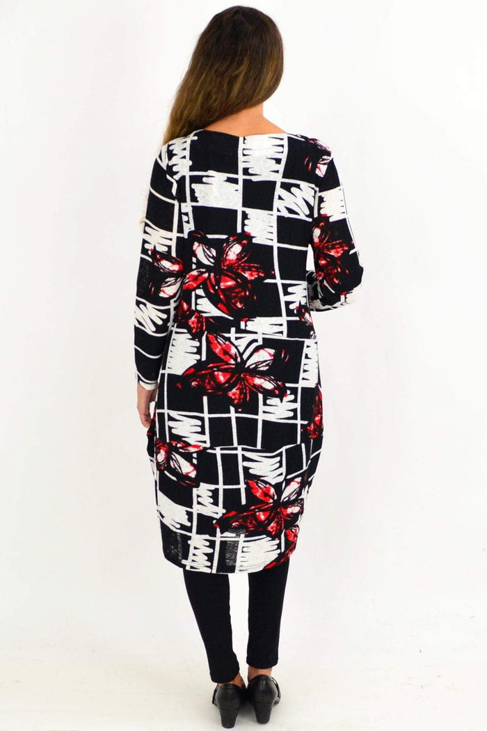 Red Butterfly Cocoon Tunic Dress by Vuios, featuring a flowing silhouette and butterfly pattern, worn by a model outdoors.
