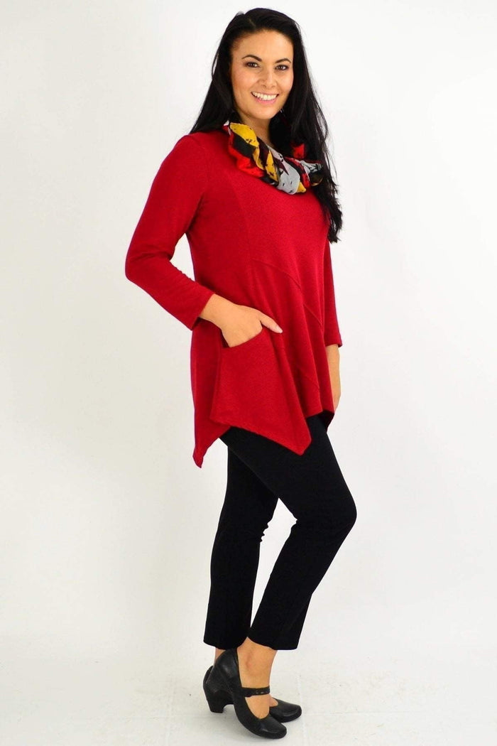 Red rust Peony winter tunic top with a pocket, featuring long sleeves and a relaxed fit, displayed on a hanger.