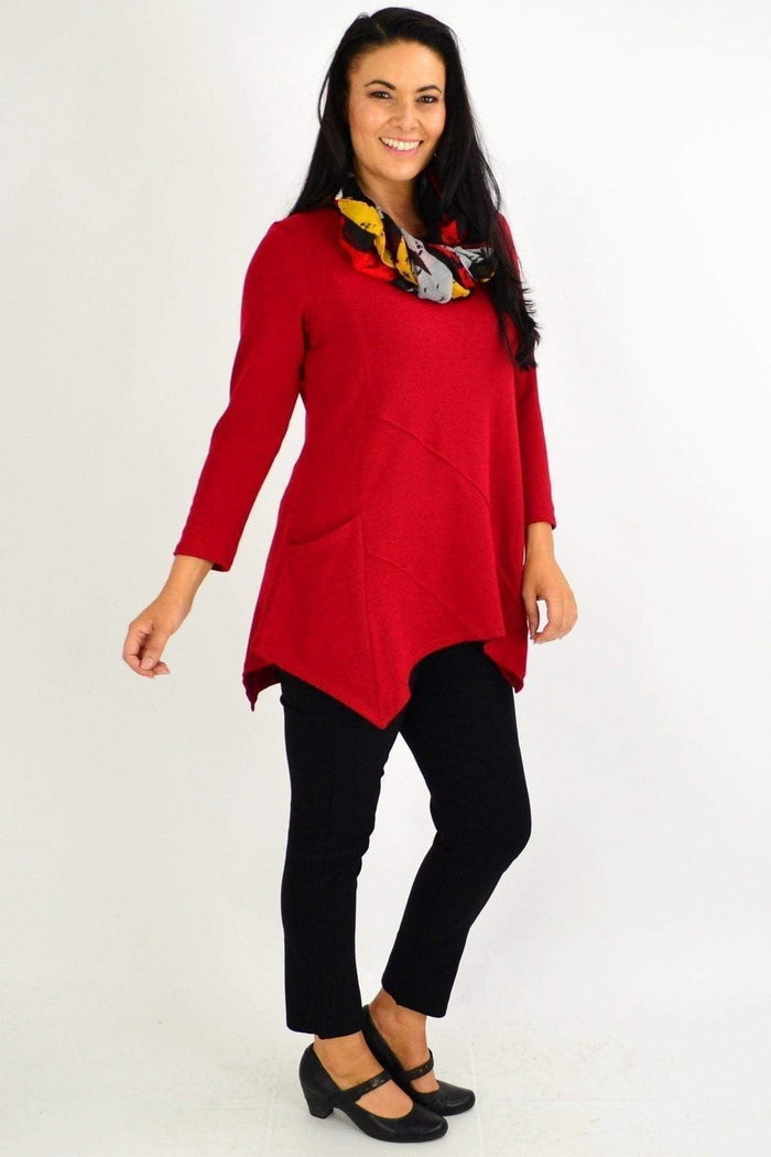 Red rust Peony pocket winter tunic top with long sleeves and a relaxed fit, shown on a hanger.