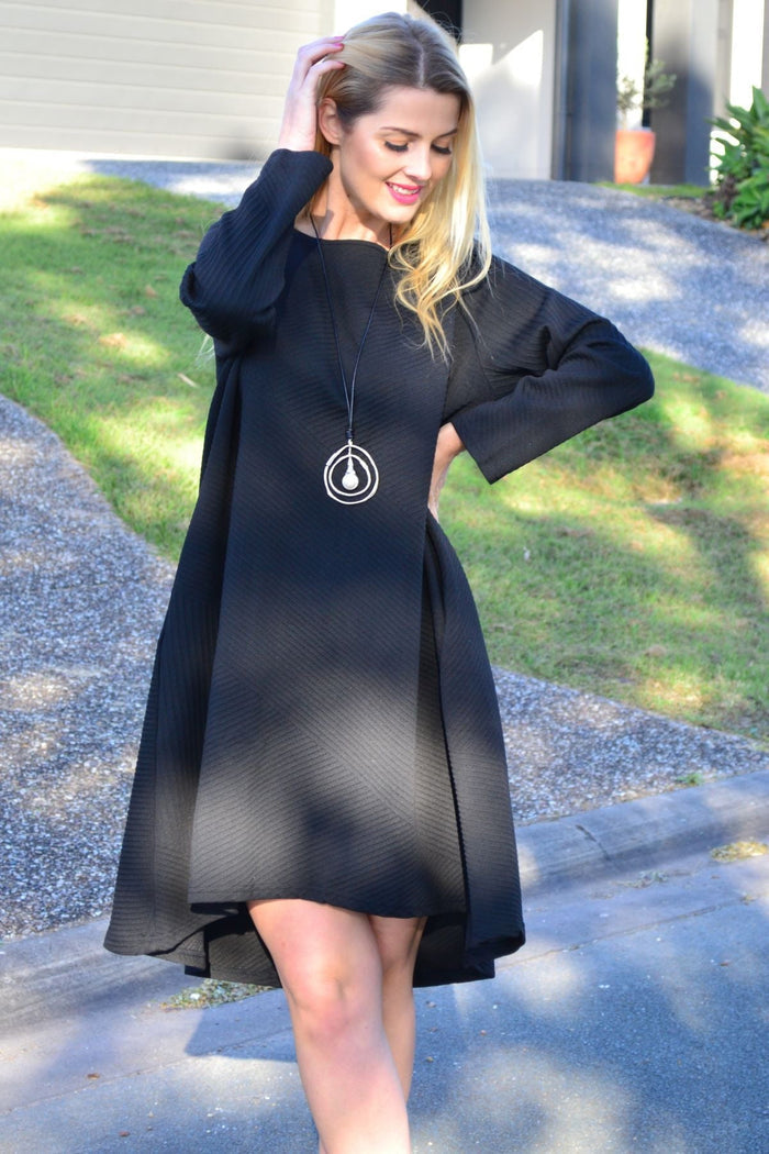 Relaxed black textured tunic dress by Poney, displayed on a model, showcasing its flowy fit and stylish design.