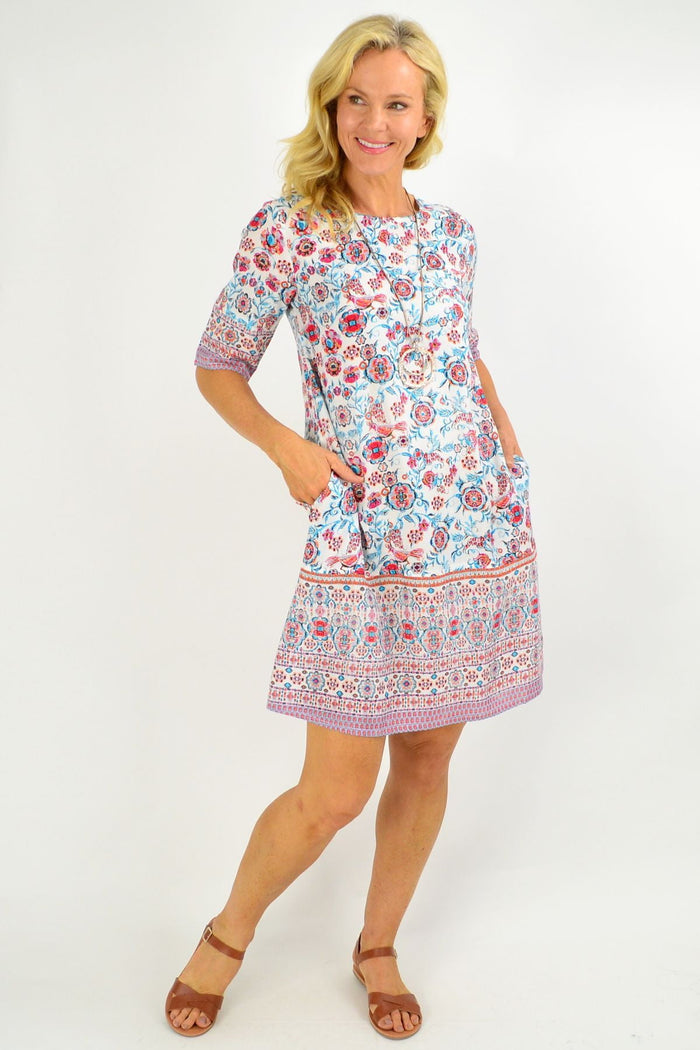 Orientique Ronda Shift Tunic Dress displayed on a hanger with colorful, flowing fabric and a relaxed fit.