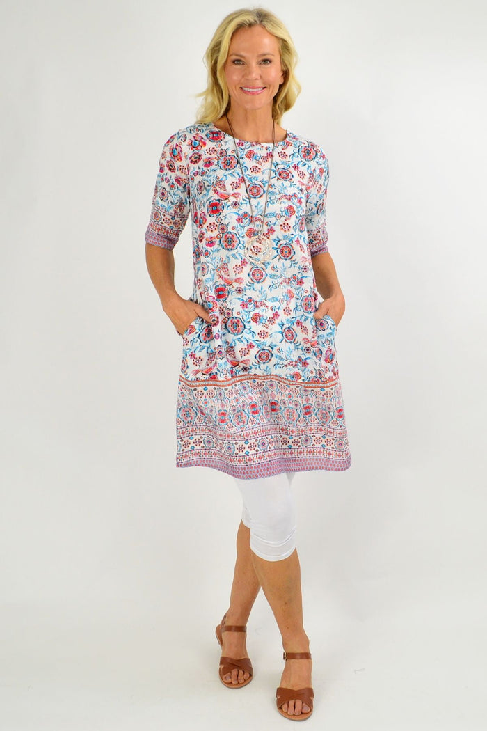 Orientique Ronda Shift Tunic Dress in vibrant print, casual fit, lightweight fabric, shown on a hanger.