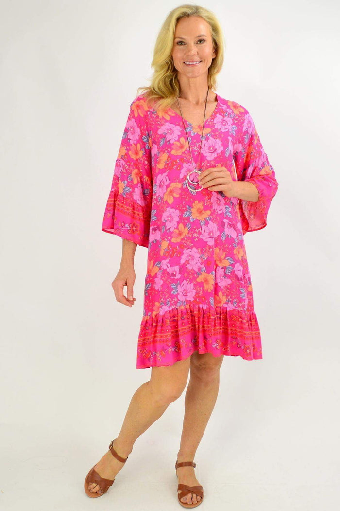 Pink floral Lottie Tier Tunic Dress by Boho Australia, displayed with ruffled tiers and long sleeves in a soft pink shade.
