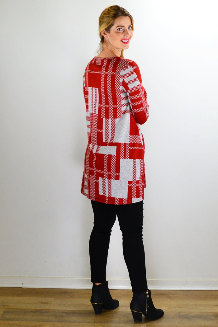 Rust grey knit tunic top by Hourglass, featuring a cozy, textured fabric and a relaxed fit, displayed on a hanger.