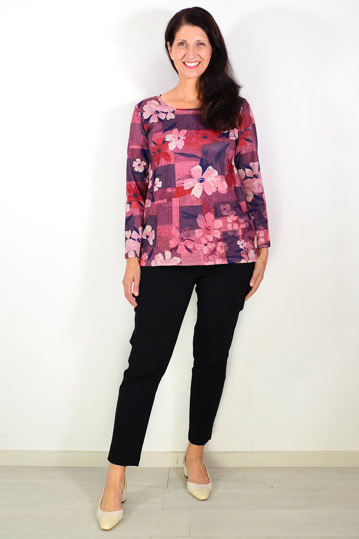 Salmon pink floral print tunic top by Hourglass, showing lightweight fabric, floral design, and relaxed fit on a model.