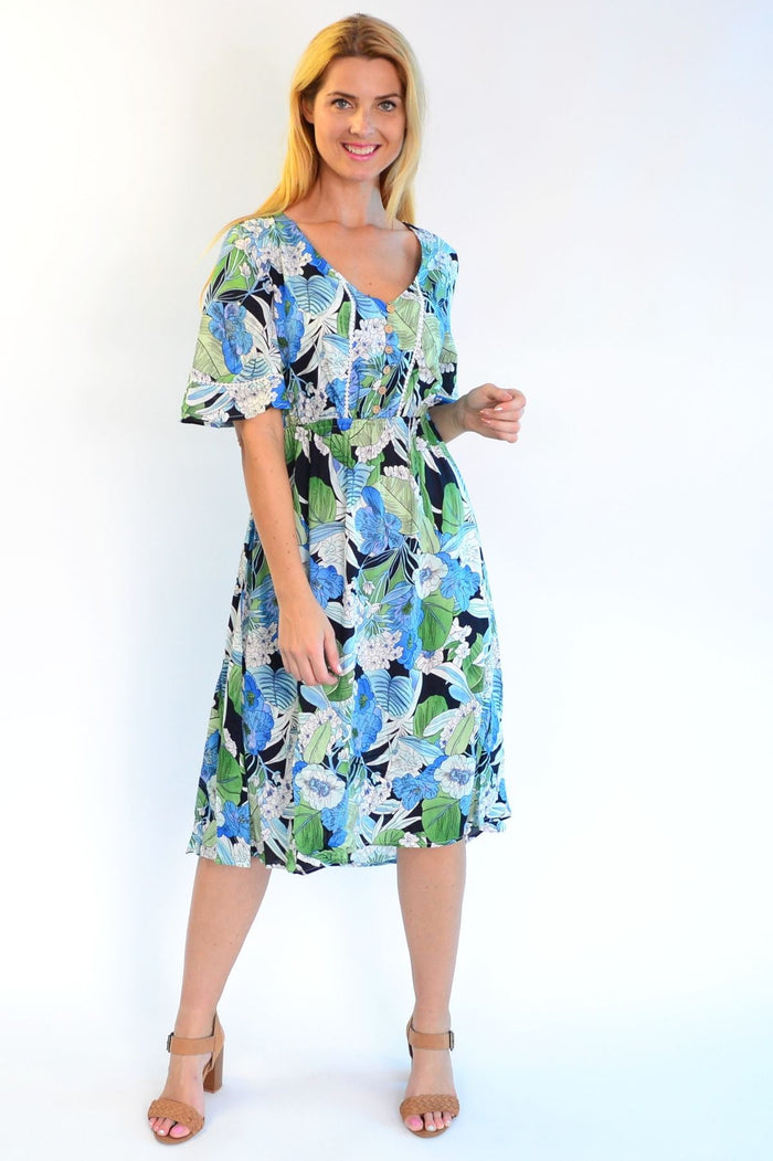 Tropical lace trim Aztec Haze Zen Garden tunic dress with colorful pattern and relaxed fit, displayed on a hanger.
