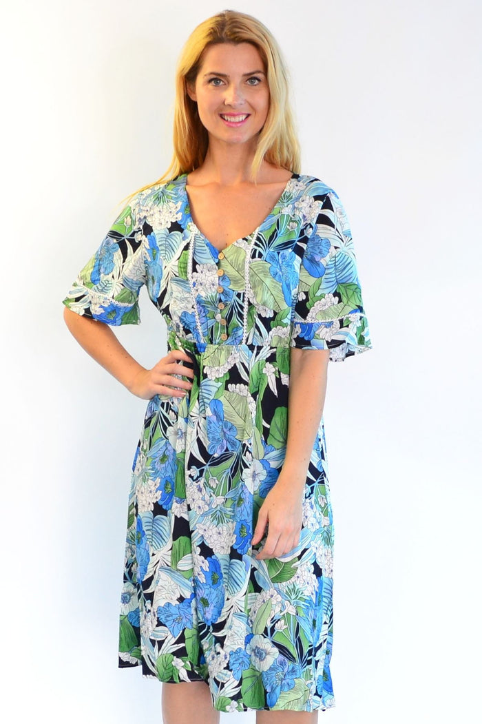 Tropical lace trim Aztec Haze Zen Garden tunic dress featuring vibrant patterns and lightweight fabric, displayed on a hanger.