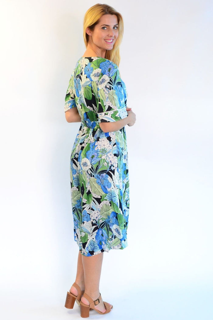 Tropical lace trim Aztec Haze tunic dress by Zen Garden, featuring vibrant patterns and lace details, hanging on a hanger.