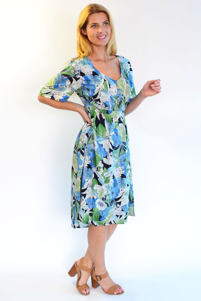 Tropical lace trim Aztec Haze Zen Garden tunic dress featuring colorful patterns and lightweight fabric, displayed on a hanger.
