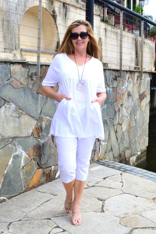 White beach day tunic top by HQ, lightweight and flowy, shown on a model with a relaxed fit and casual style.