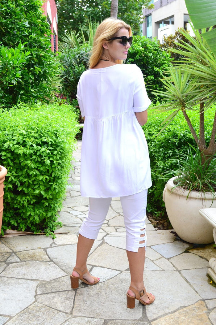 White Beach Day Tunic Top by HQ, lightweight and breezy, shown hanging on a wooden hanger with a relaxed fit.