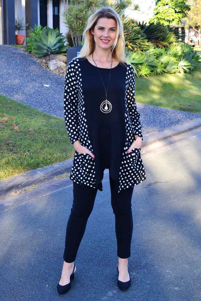 White and black pockets and dots winter tunic top by Peony, featuring a cozy, stylish design with front pockets and a relaxed fit.