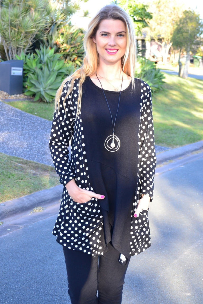 White and black pockets and dots winter tunic top by Peony, featuring a stylish and comfortable design with pockets and a dotted pattern.