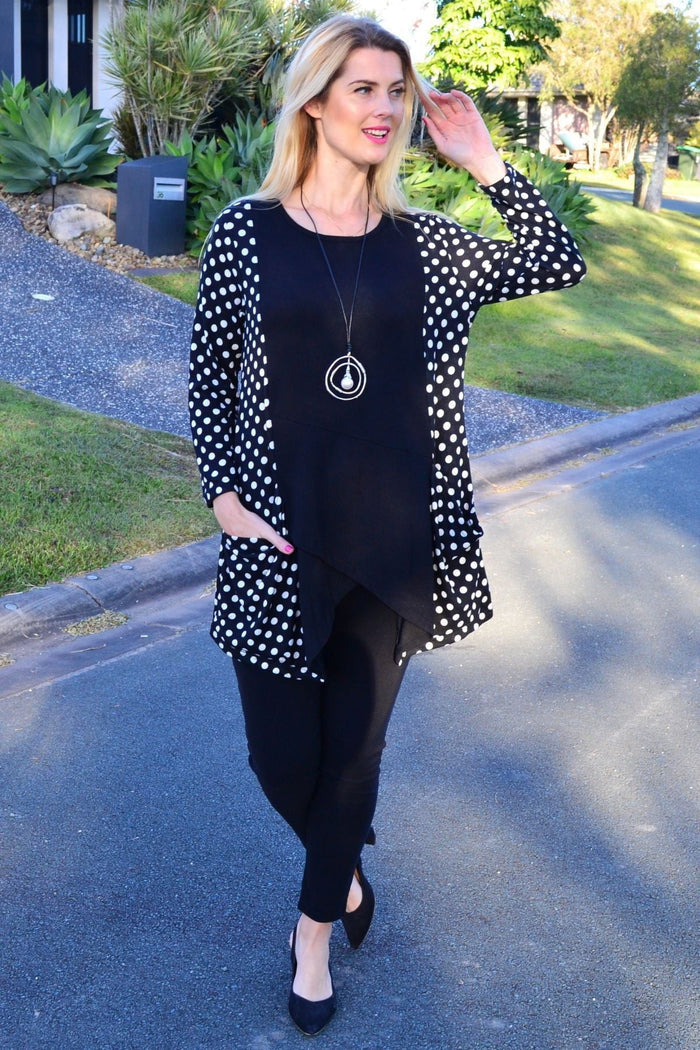White and black pockets and dots winter tunic top by Peony, featuring a cozy, stylish design with a relaxed fit.