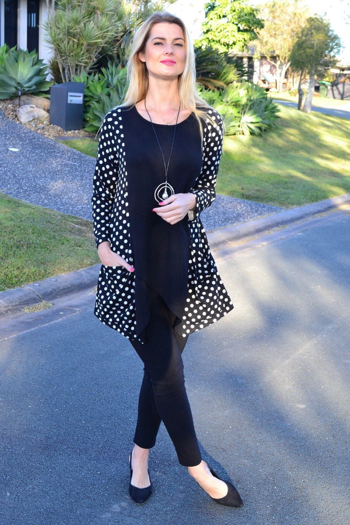 White and black pockets and dots winter tunic top by Peony, featuring a cozy, stylish design with a relaxed fit.