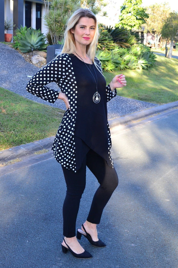White and black pockets and dots winter tunic top by Peony, featuring a cozy, stylish design with contrasting patterns.
