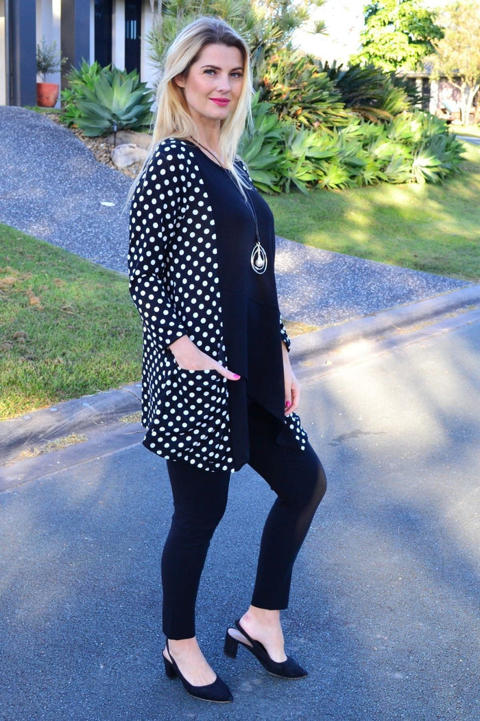 White and black pockets and dots winter tunic top by Peony, featuring a stylish, cozy design with contrasting patterns.