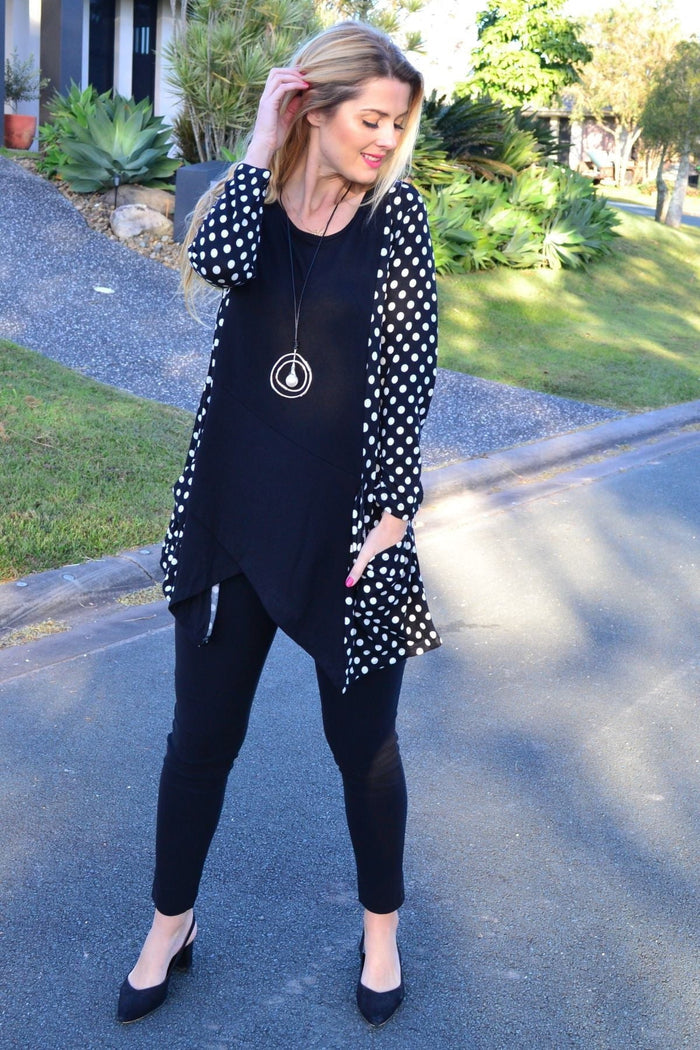 White and black pockets and dot pattern winter tunic top by Peony, featuring long sleeves and cozy fabric.