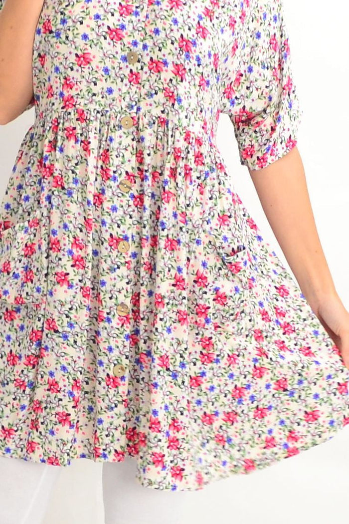 White coconut button pocket tunic dress by Silver Wishes, featuring a relaxed fit with front pockets and button details.