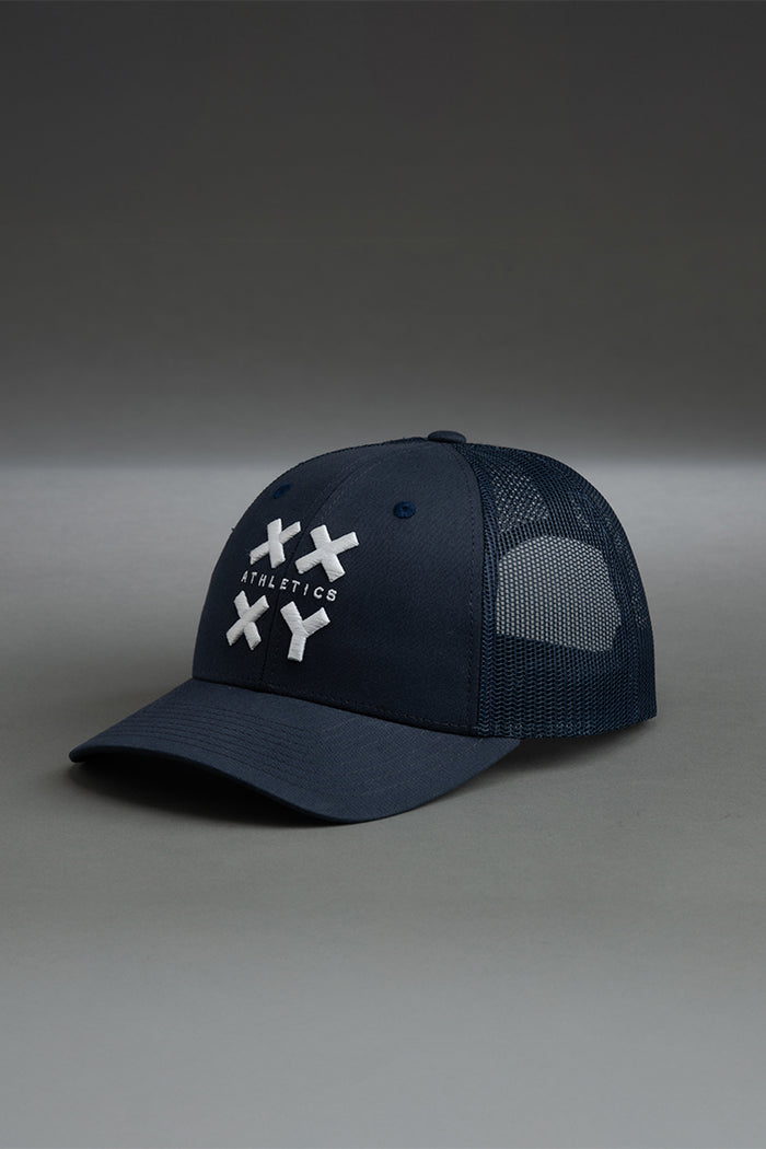 Navy blue cap with white logo on a gray background || navy with white logo