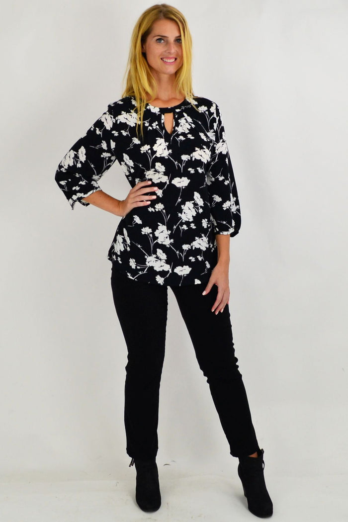 White flower pattern tunic by Envogo, featuring a stylish black and white floral design, perfect for casual or elegant wear.