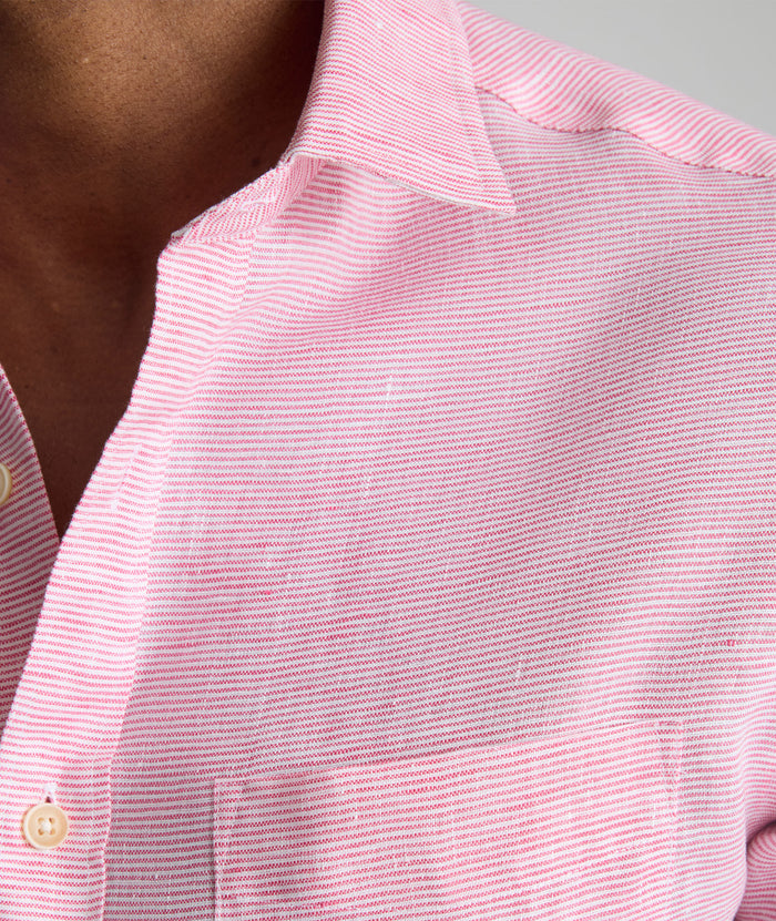 Model is wearing UNTUCKit Wrinkle-Resistant Linen Wildehart Shirt in pink.