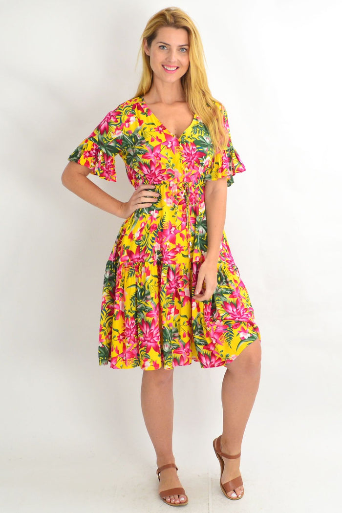 Yellow frilly orchid tunic dress by Willow Tree featuring pink floral patterns and a flowing, lightweight design.