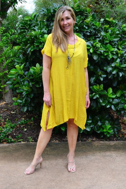 Yellow oversized drop shoulder tunic dress by Wishstone, flowing fabric with relaxed fit and long sleeves, displayed on a hanger.