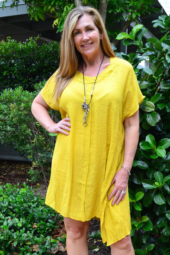 Yellow Wishstone oversized drop shoulder tunic dress hanging on a hanger, showcasing its relaxed fit and vibrant color.