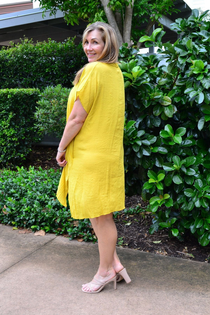 Yellow Wishstone oversized drop shoulder tunic dress with relaxed fit and short sleeves, displayed on a hanger.