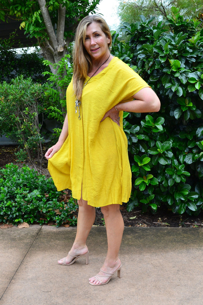 Yellow Wishstone oversized drop shoulder tunic dress with relaxed fit and long sleeves, displayed on a hanger.